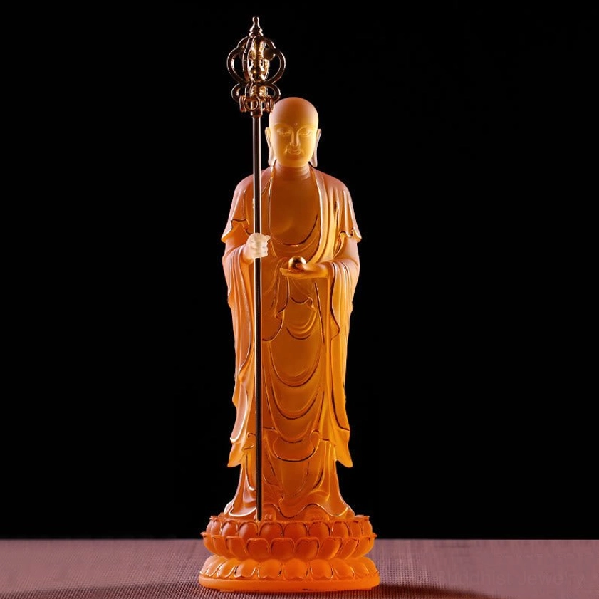 Close-up front view of amber Ksitigarbha Bodhisattva liuli crystal statue highlighting robe line details