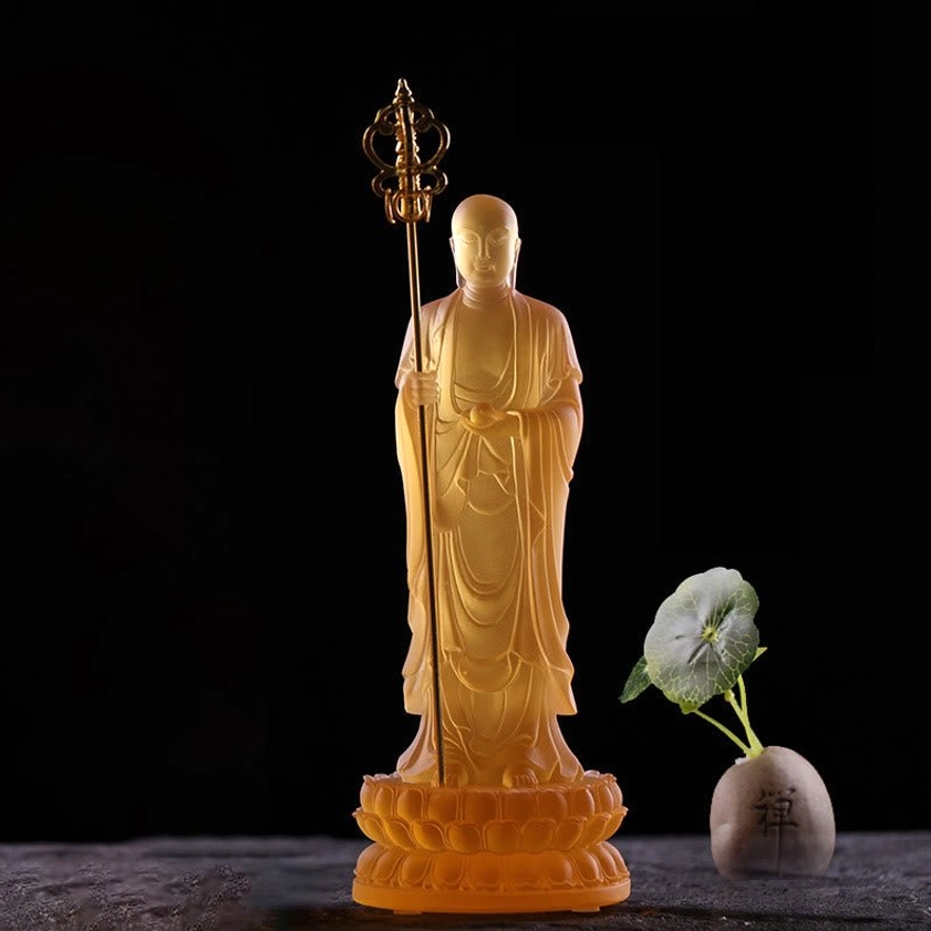 Single amber translucent Ksitigarbha Bodhisattva liuli crystal statue showing detailed robe folds and compassionate expression