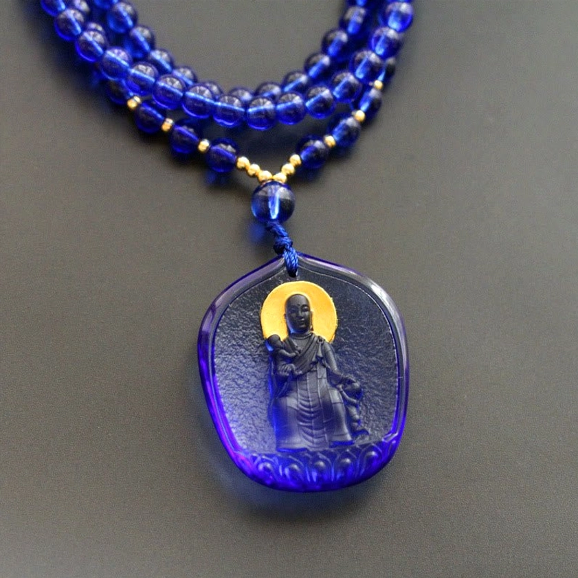 Ksitigarbha Bodhisattva seated with child dark blue Liuli crystal pendant, Buddhist protection necklace