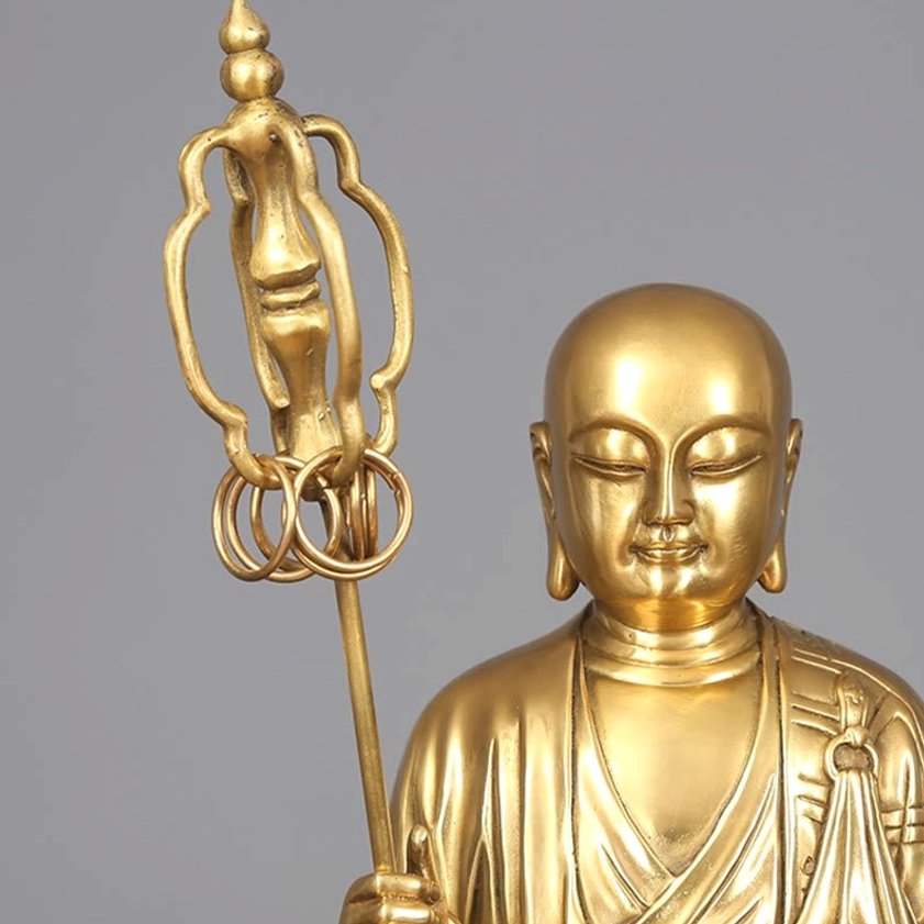 Close-up of Ksitigarbha Bodhisattva head and shoulder detail with serene expression and six-ring prayer staff
