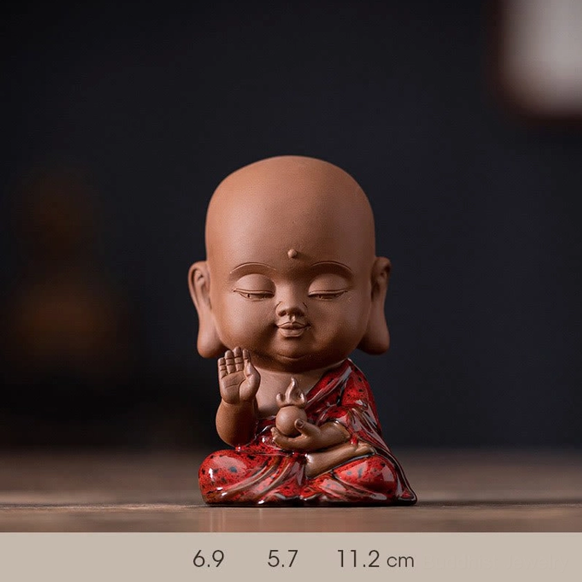 Ksitigarbha Bodhisattva ceramic figurine close-up showing detailed sculpting hand-glazed robes and peaceful expression for spiritual guardian energy