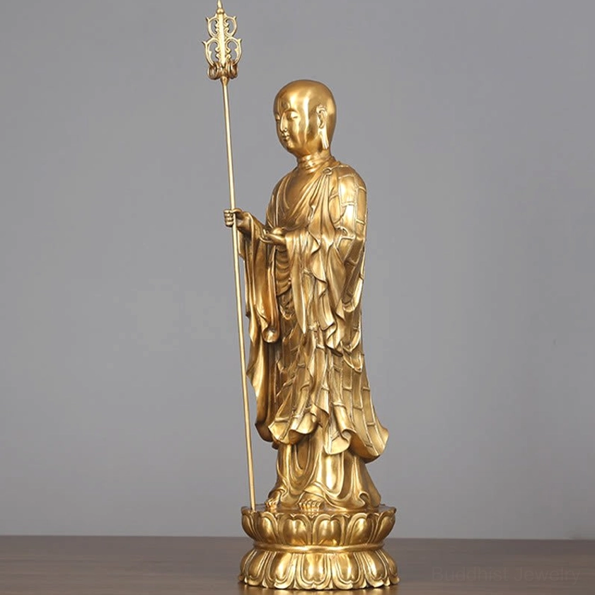 Ksitigarbha Bodhisattva statue detail showing lotus pedestal base and sacred dharma staff