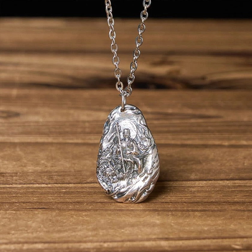 Handmade Ksitigarbha Buddhist pendant with matte silver finish and thin curb chain, top-down close-up view