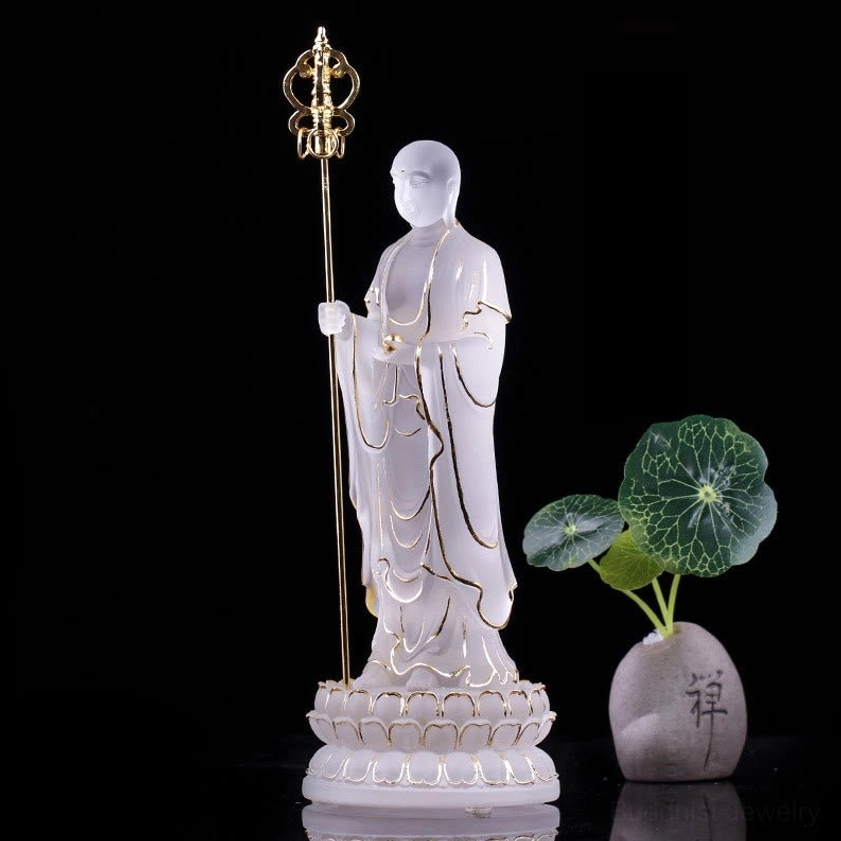 White frosted Ksitigarbha Bodhisattva liuli crystal statue with golden khakkhara on decorative mat