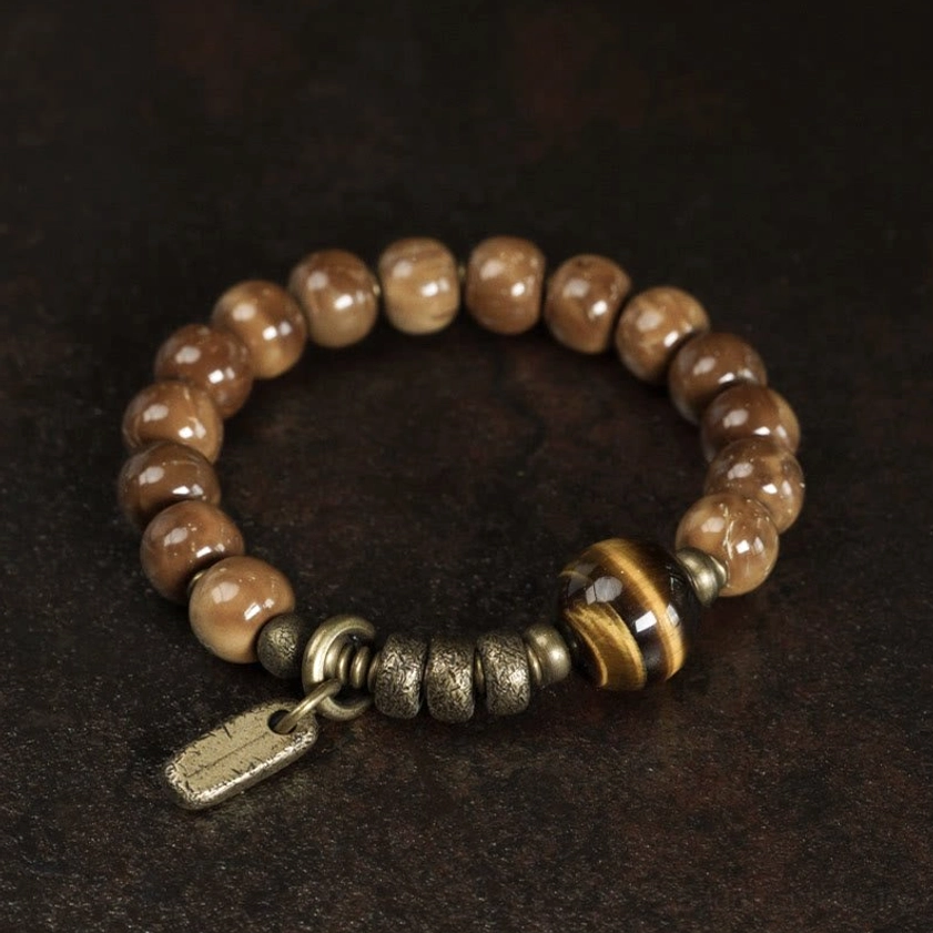 Plain round brown bead bracelet with hematite focal stone and brass tag