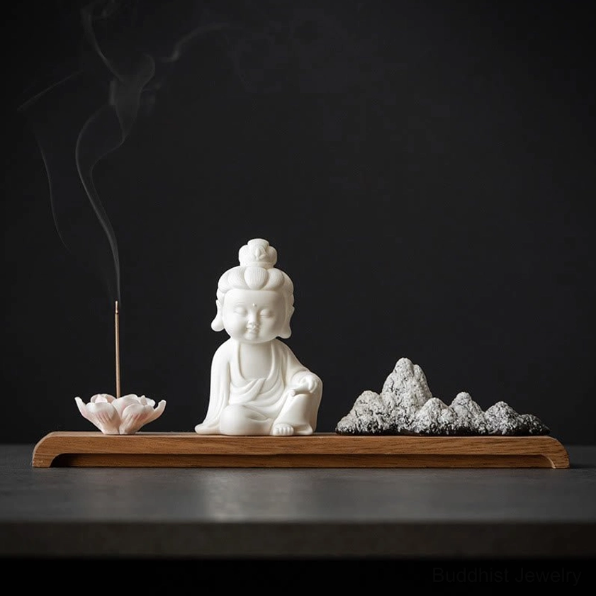 Kwan Yin Avalokitesvara ceramic incense burner with lotus holder on dark wooden table, compassion symbol