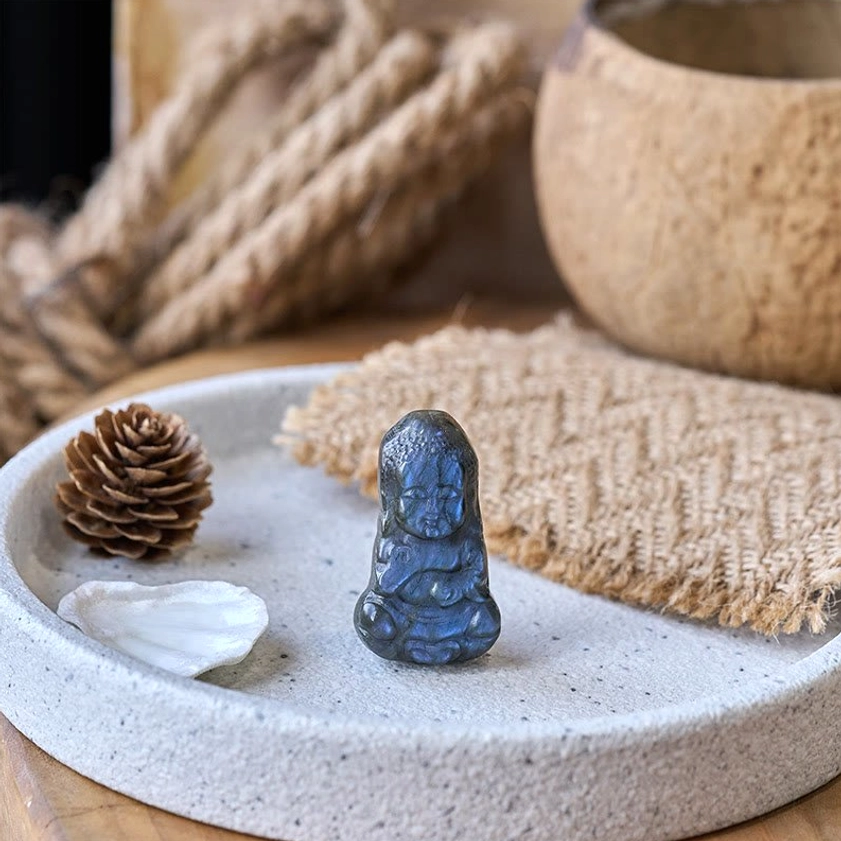 Side overhead view of handcarved labradorite Buddha statue showing seated meditation carving style
