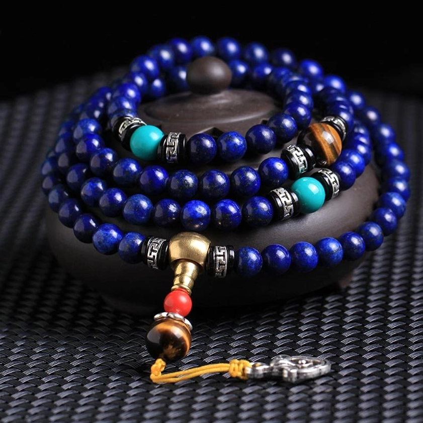 108 bead lapis lazuli mala bracelet with tiger eye turquoise and silver accents displayed on ceramic incense holder - Buddhist prayer beads
