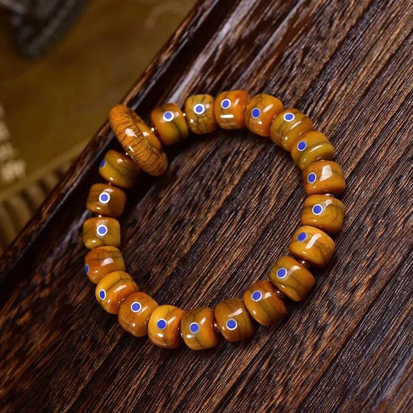 Close-up detail of lapis lazuli inlaid bone beads with copper trim on Buddhist healing bracelet