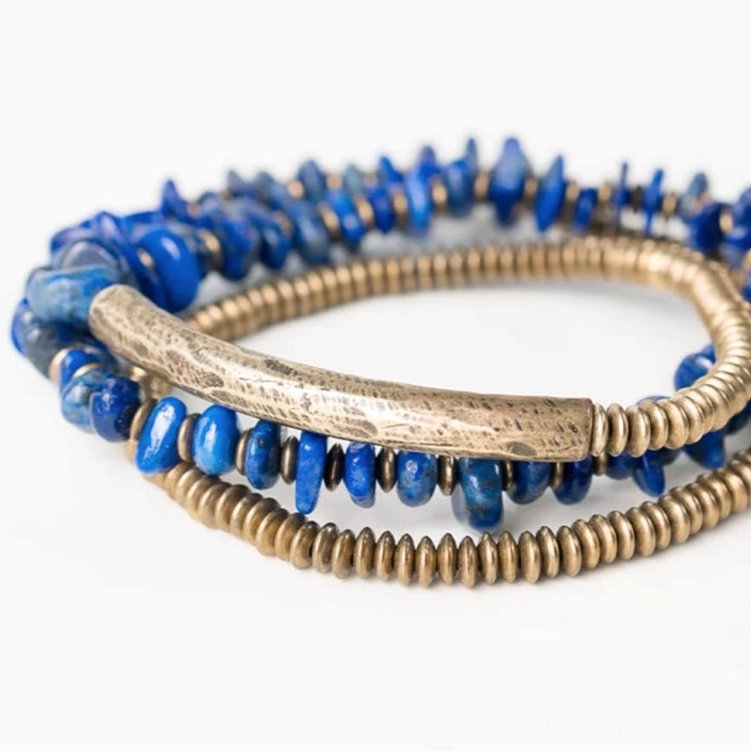 Close-up front view of lapis lazuli beads and antiqued bronze tube charm on triple wrap bracelet, crystal healing details