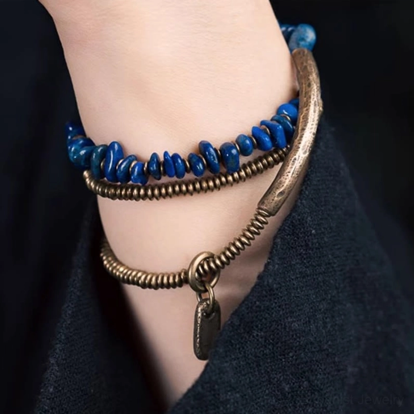 Lapis lazuli triple wrap Buddhist bracelet with natural stone variations and handmade craftsmanship details visible