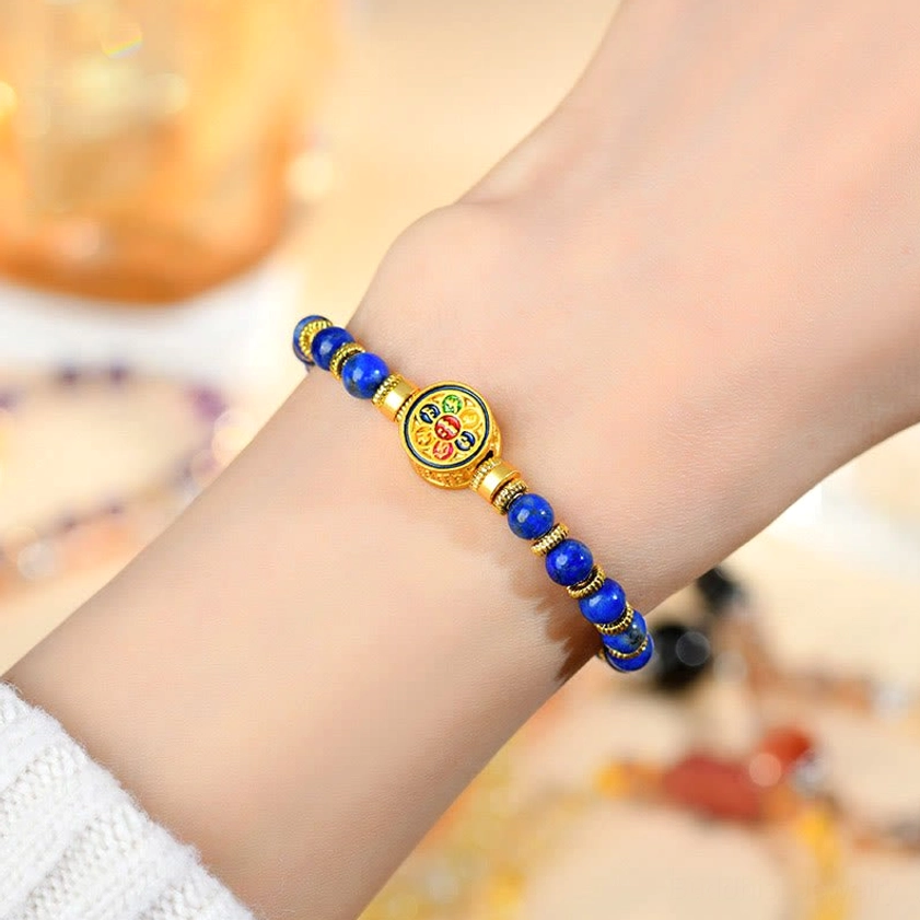 Lapis lazuli om mani padme hum bracelet fitted on wrist showing wearable fit and blue stone beauty