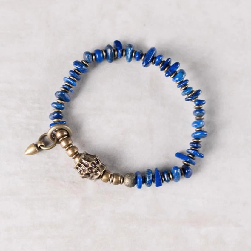 Bright blue lapis lazuli chip bracelet with irregular shaped beads on neutral background, flat lay photography