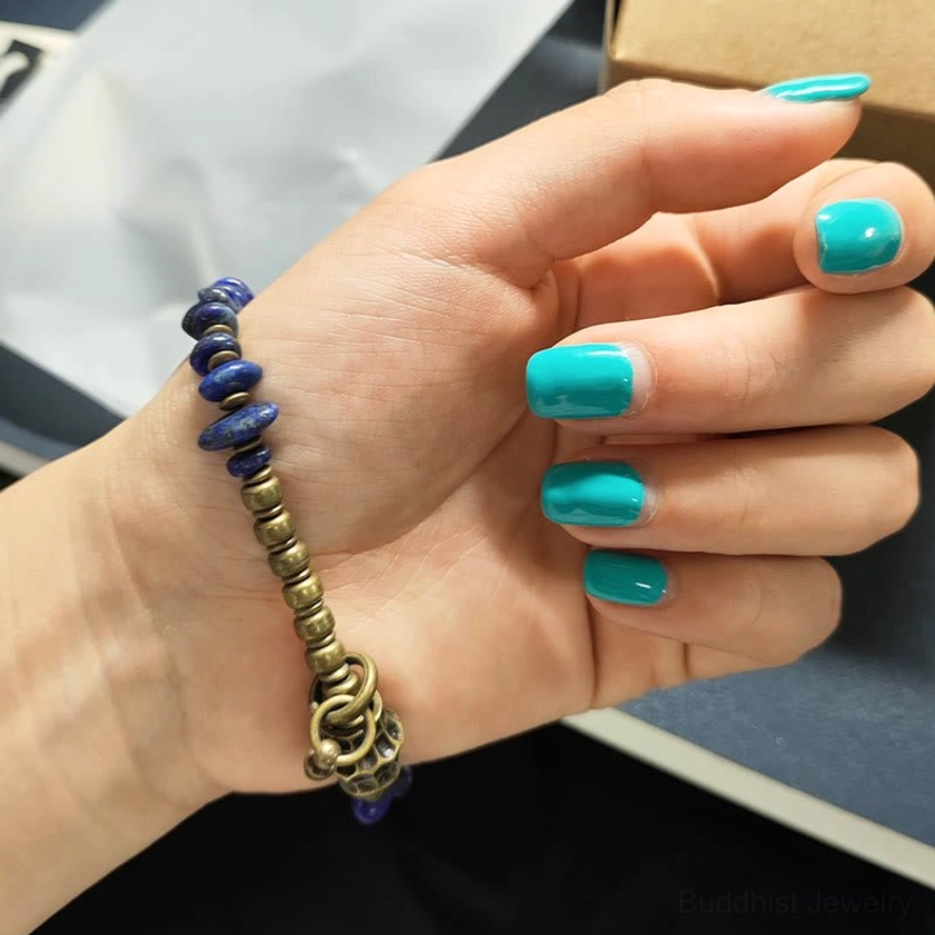 Handcrafted lapis lazuli chip bracelet featuring natural stone irregularities and artisanal metal bead details