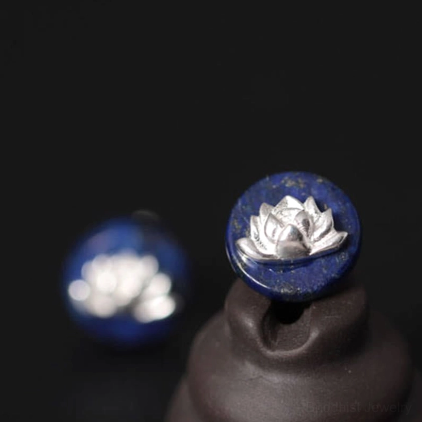 Lapis lazuli lotus stud earrings pair displayed on dark leather background product shot