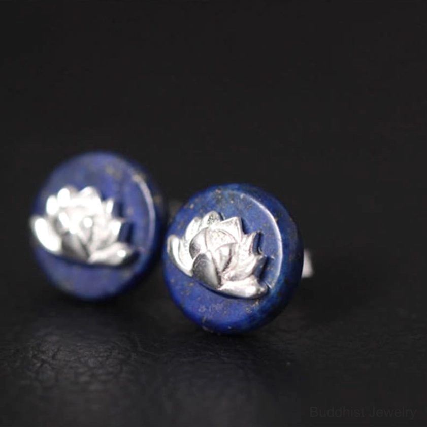 Side profile view of lapis lazuli lotus earrings showing embossed silver lotus motif on blue stone