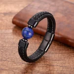 Lapis Lazuli Om Mani Padme Hum leather bracelet with blue stone bead, displayed on wooden desk with black braided leather strap and metal clasp