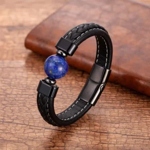 Lapis Lazuli Om Mani Padme Hum leather bracelet with blue stone bead, displayed on wooden desk with black braided leather strap and metal clasp