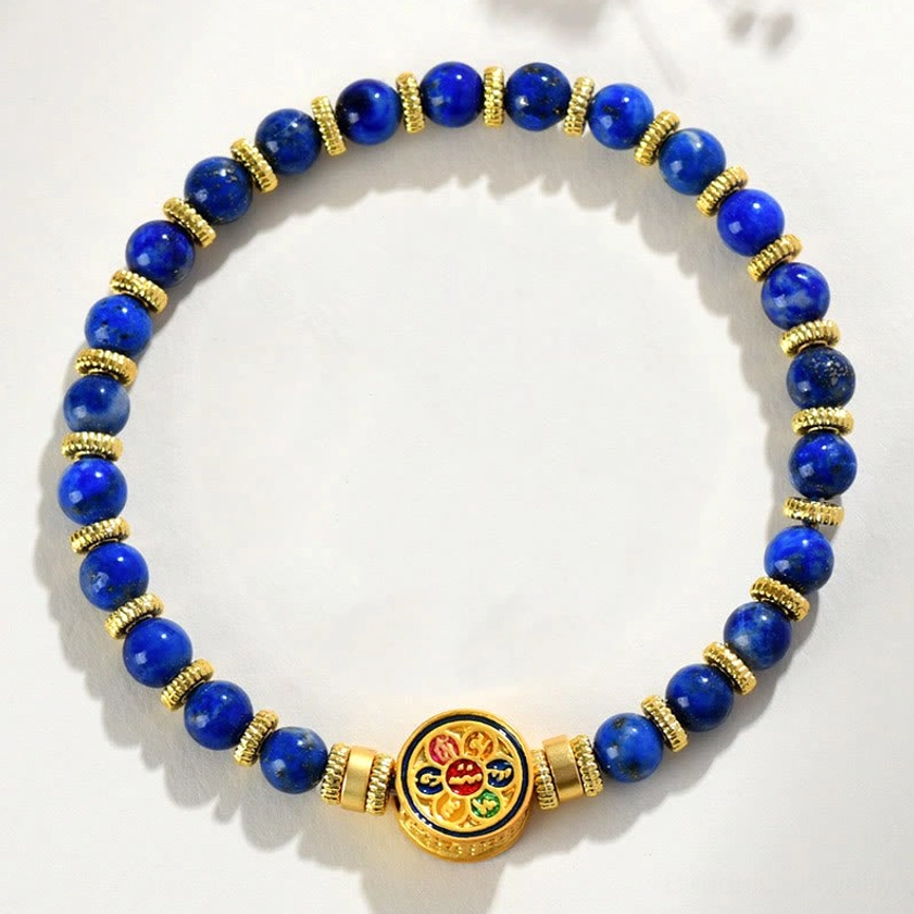 Blue lapis lazuli prayer bracelet showing round beads and central religious medallion detail