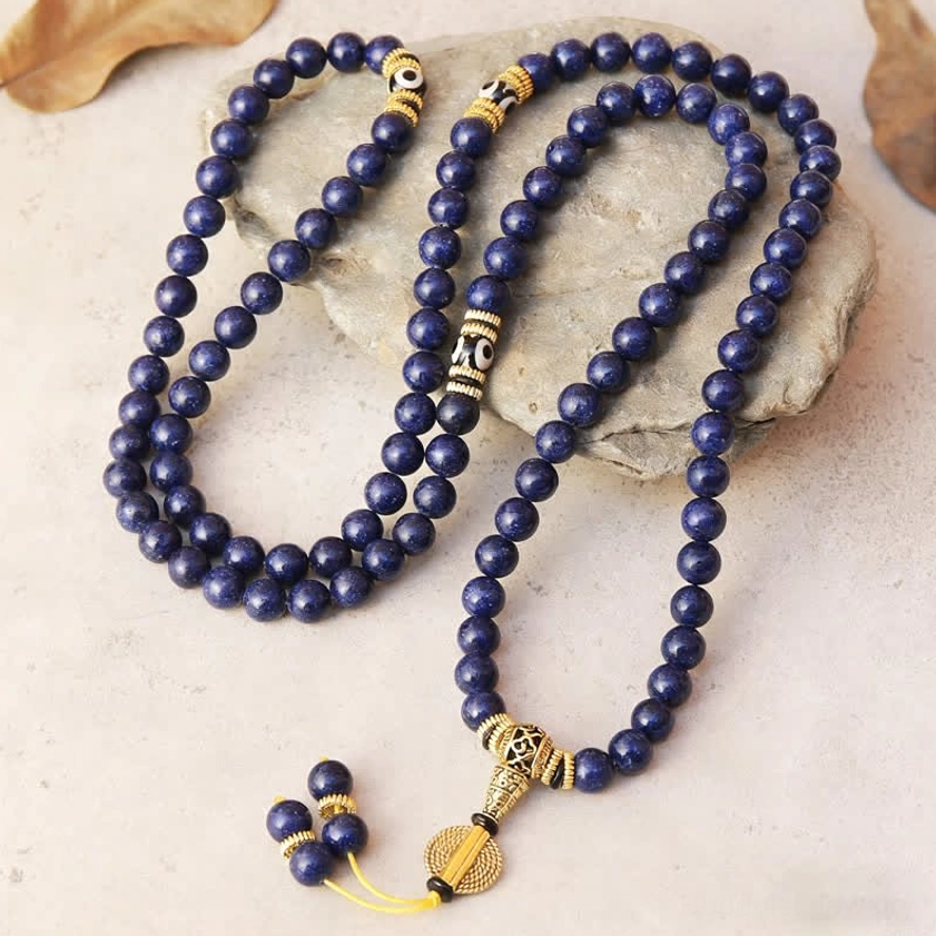 Buddhist prayer mala made of deep blue lapis lazuli beads with gold spacers and traditional tassel pendant