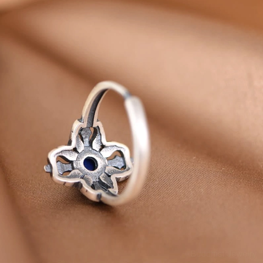 Back of lapis lazuli ring showing hollow carved cross pattern and open adjustable band construction
