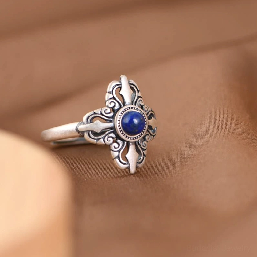 Sterling silver lapis lazuli ring left side oblique view, detailed floral carvings with natural blue stone