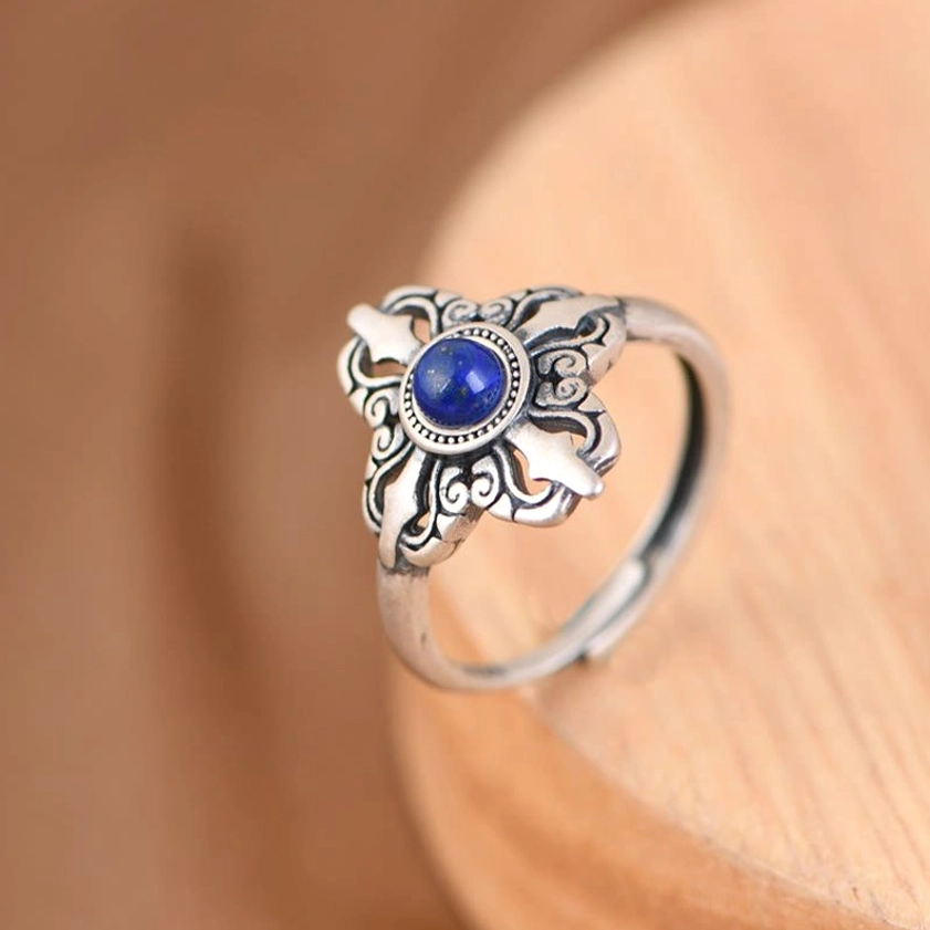 Buddhist lapis lazuli silver ring side view, ornate filigree carving with natural blue stone centerpiece
