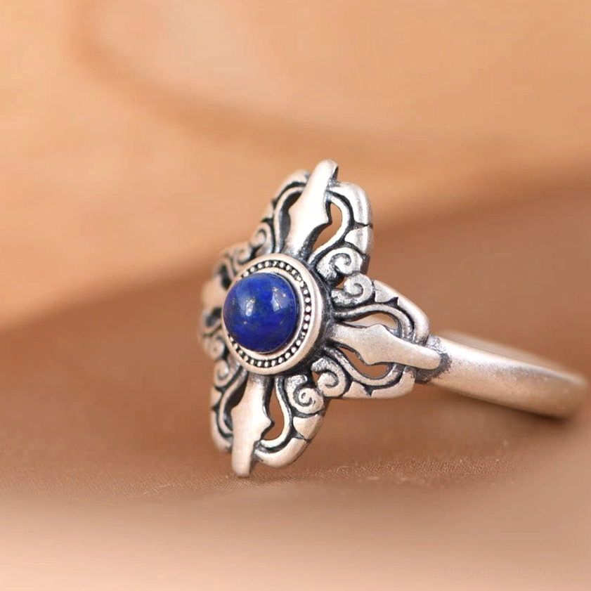 Adjustable lapis lazuli ring showing vajra cross pattern, vintage silver finish with blue gemstone detail