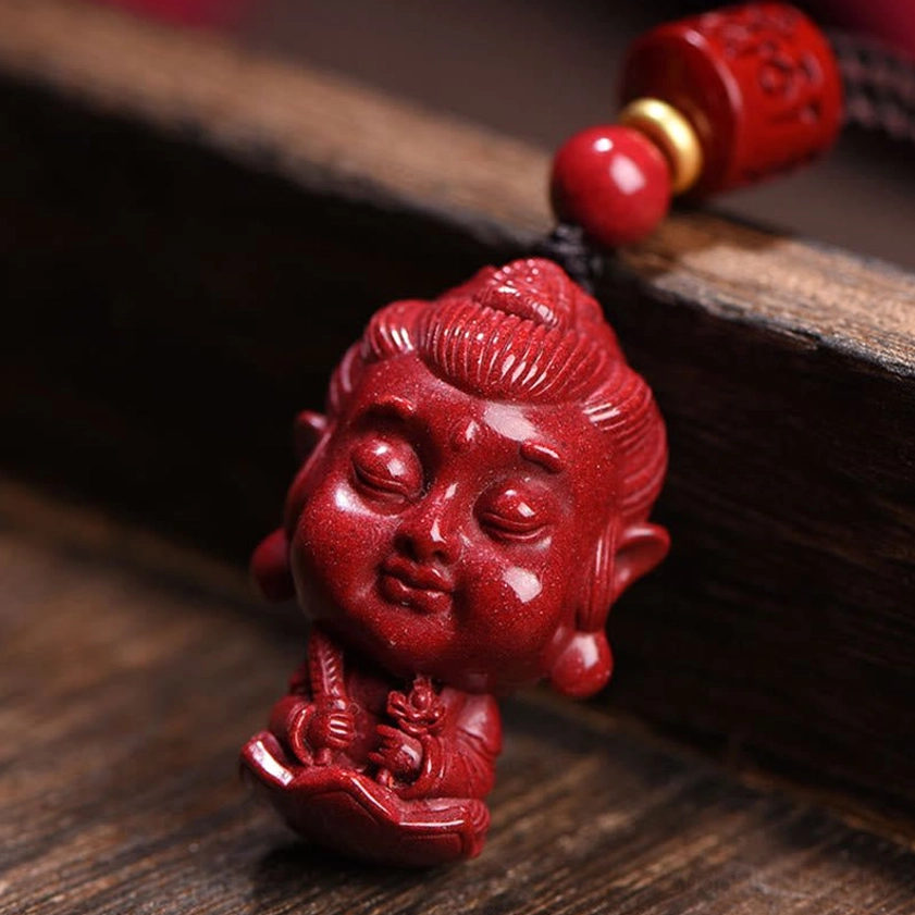 Large carved cinnabar bodhisattva Buddha pendant with detailed religious iconography