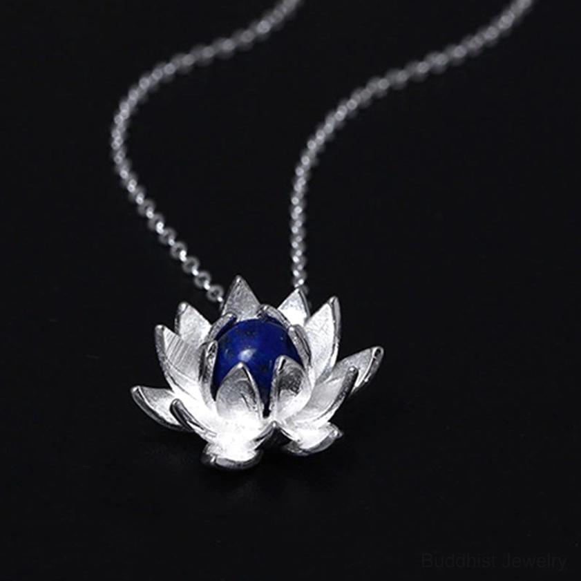 Large 3D lapis lazuli lotus flower sterling silver necklace pendant, overhead angled view showing prominent blue gemstone center and detailed silver petals