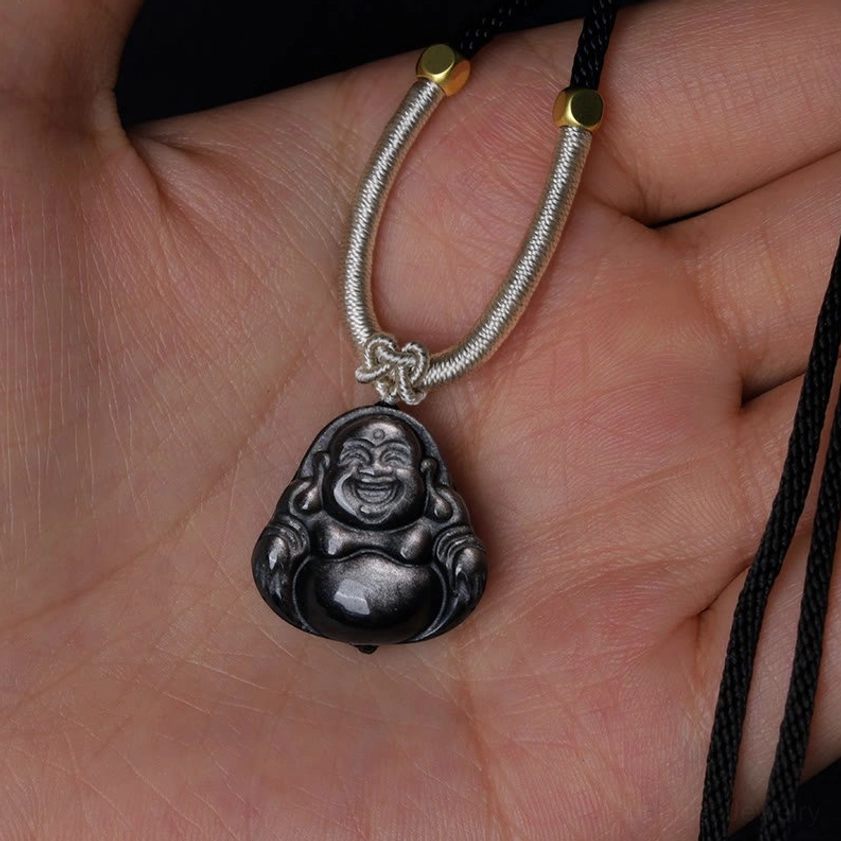 Large silver sheen obsidian Laughing Buddha pendant centered close-up, prominent polished silver sheen surface with full front Buddha carving