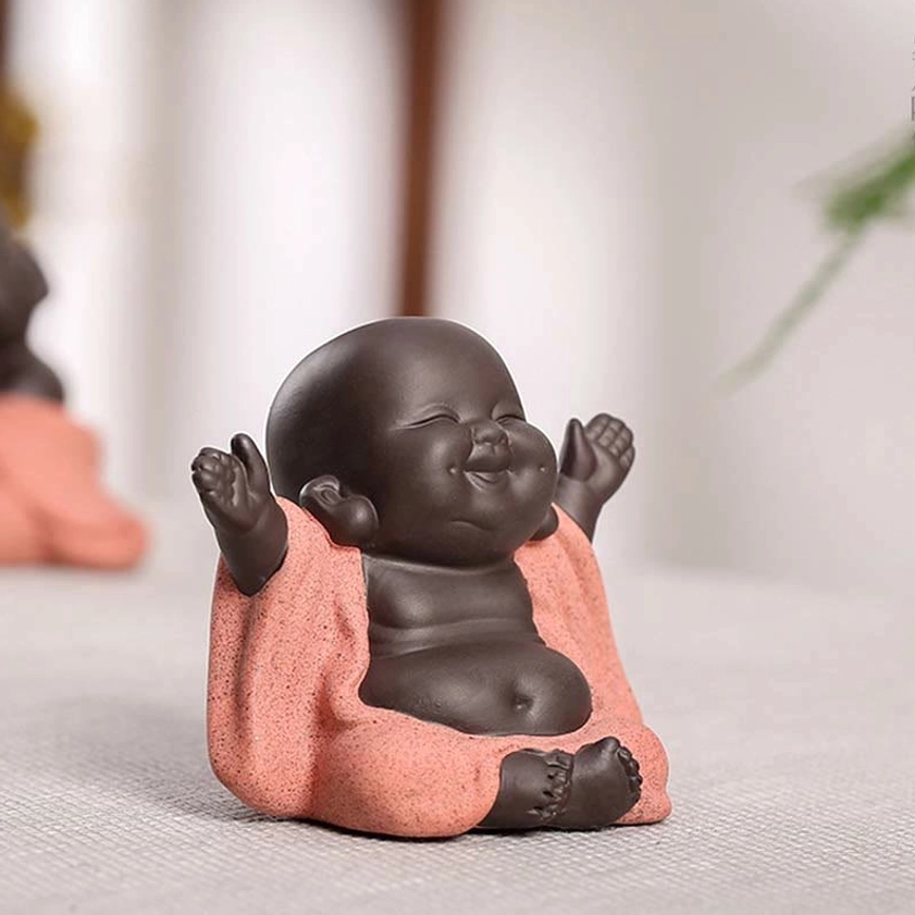 Baby monk decoration showing three-quarter right view with exposed belly and crossed feet, authentic Buddhist figurine