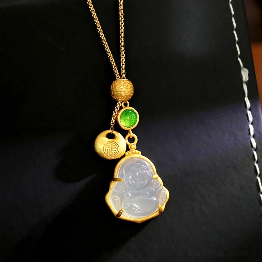Laughing Buddha chalcedony copper necklace pendant with Fu character charm on black leather jewelry display box, showcasing gold-toned chain and green accent stone