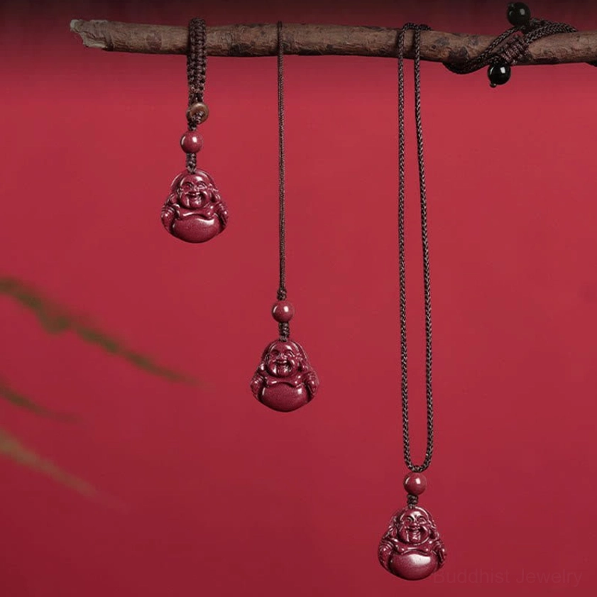 Laughing Buddha cinnabar pendants displayed on red background showing multiple rope styles and colors for necklace, phone charm, and keychain styles