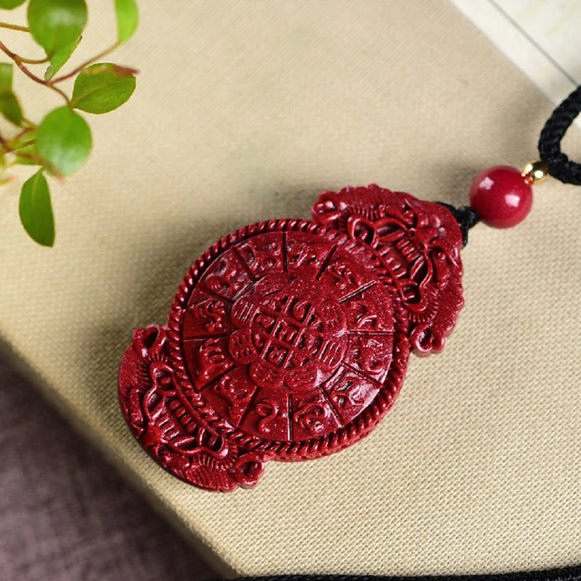 Cinnabar laughing Buddha Buddhist pendant necklace detail shot showing embossed carving and natural stone granular texture