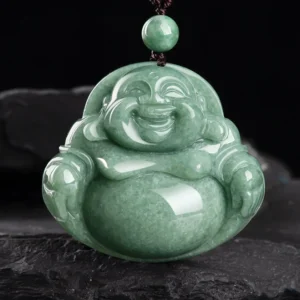 Laughing Buddha cyan jade pendant necklace with dark cord, frontal close-up view on slate background