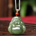 Laughing Buddha Hetian jade pendant necklace front view with braided grey cord and red bead on wooden table