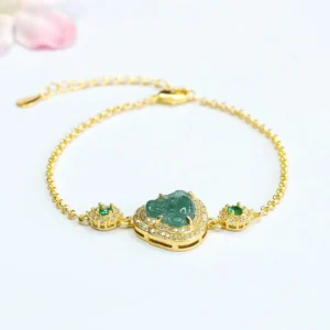 Green jade Laughing Buddha bracelet with zircon crystals and gold-plated chain on pink floral background - prosperity bracelet for good luck