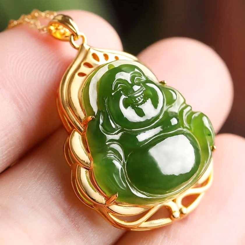 Close-up detail of smiling Maitreya Buddha jade carving with intricate gold metal detailing, held in hand