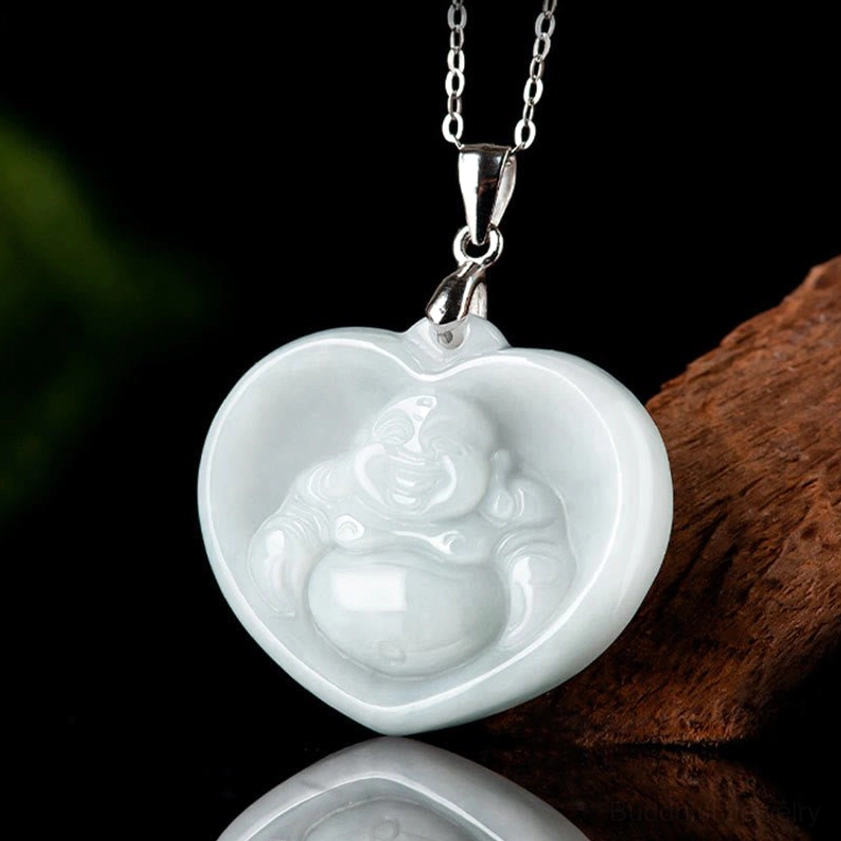 Close-up detail of white jade laughing Buddha heart pendant showing polished smooth surface and intricate Buddha carving
