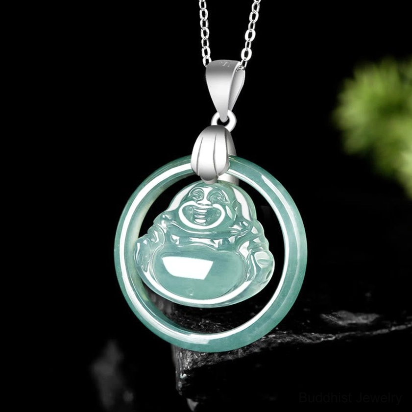 Laughing Buddha jade prosperity necklace three-quarter side angle - green jade pendant with silver hardware displayed on dark stone and foliage