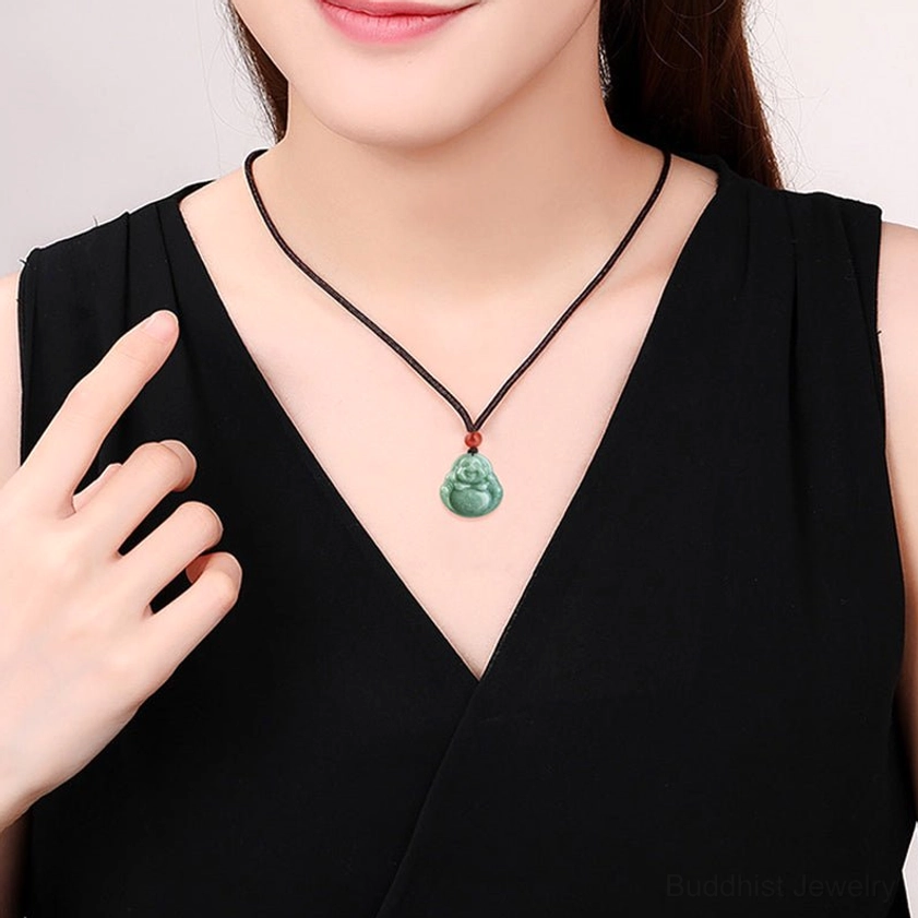 Woman wearing cyan jade Laughing Buddha necklace on neck, showing how pendant looks when worn with small Buddha pendant and red accent bead