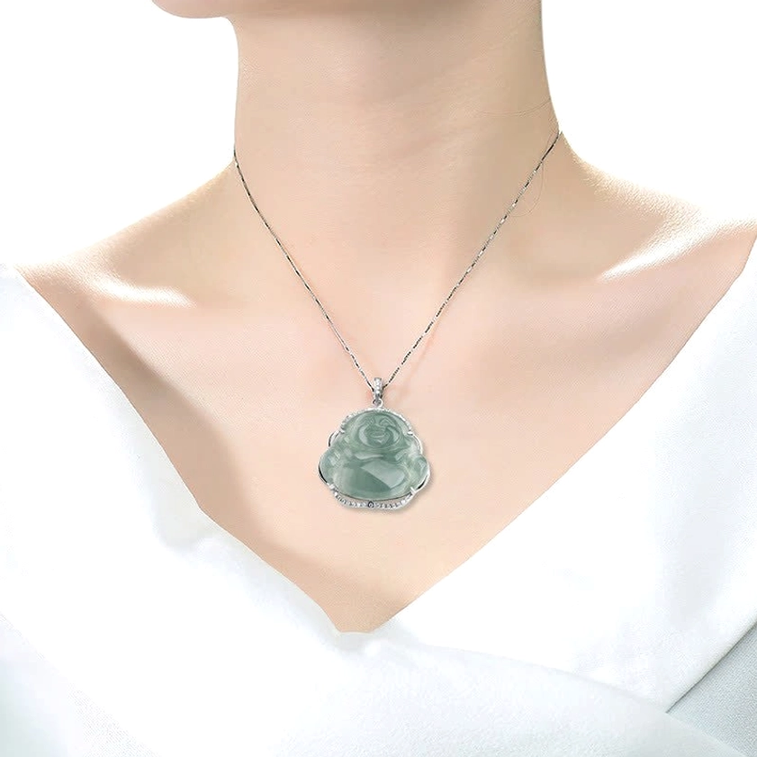 Laughing Buddha jade necklace worn on model with thin silver chain against white garment, close-up wearable view