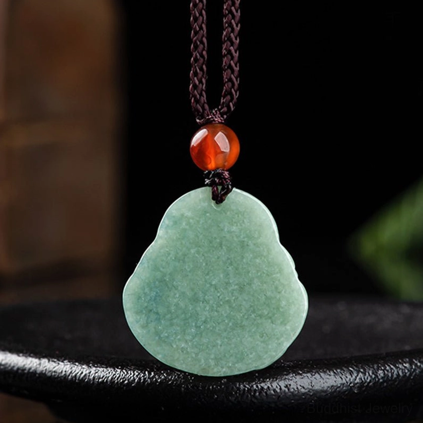 Back view of hand-carved cyan jade Laughing Buddha pendant on brown cord displaying smooth jade surface