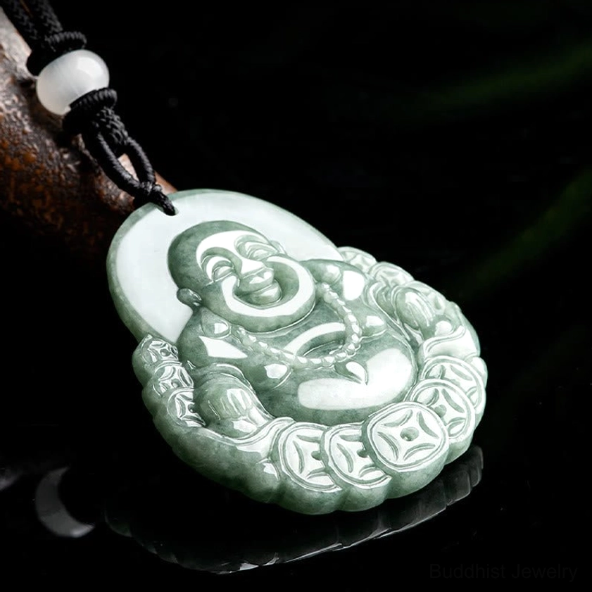 Laughing Buddha jade pendant necklace on black cord with white bead, low angle studio display