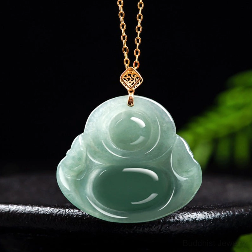 Pale green smooth carved Laughing Buddha jade pendant with fine details on dark studio background