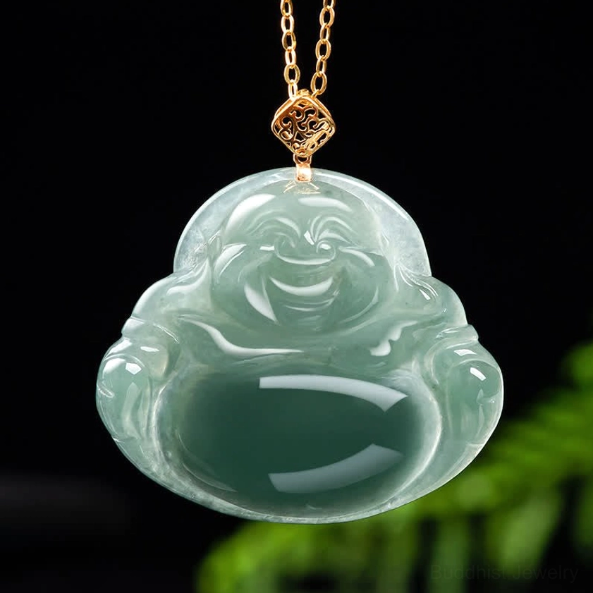 Laughing Buddha jade pendant close-up with natural light green stone and gold decorative clasp on dark foliage background