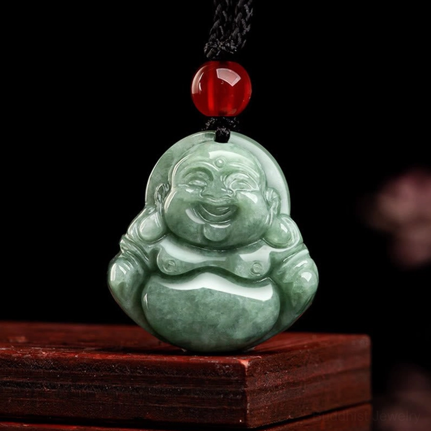 Direct front view of hand-carved green jade Laughing Buddha Buddhist pendant showing detailed facial features