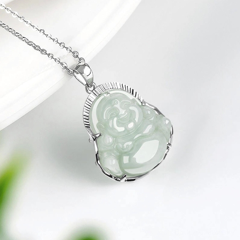 Pale green jade Buddha pendant left side close-up showing smooth natural jade stone texture and titanium steel frame