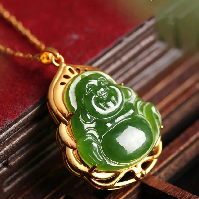 Natural Hetian jade Maitreya Buddha pendant with decorative gold frame, oblique angle with wooden jewelry box backdrop